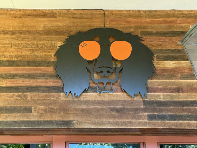 Decorative lion head sign for Heir of The Dog at eCorsair, Pensacola State College.