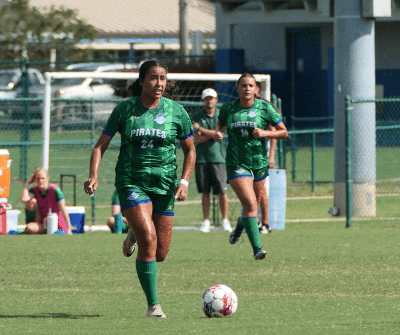 Women’s soccer team at Pensacola State College playing on the field.