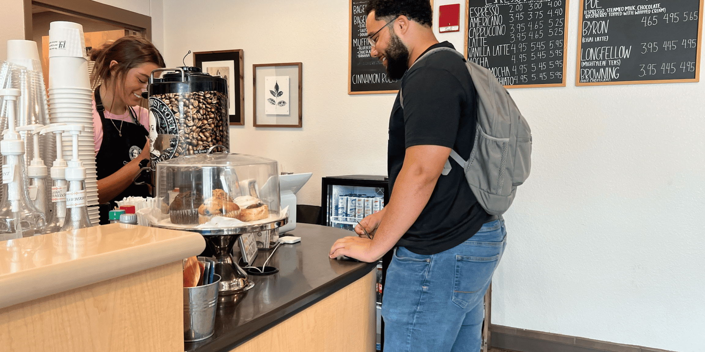 Student paying with card at coffee shop counter for eCorsair.