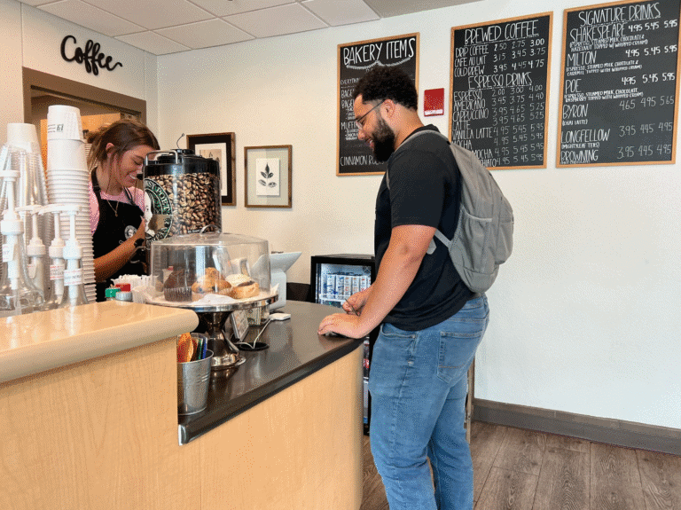 Student paying with card at coffee shop counter for eCorsair.