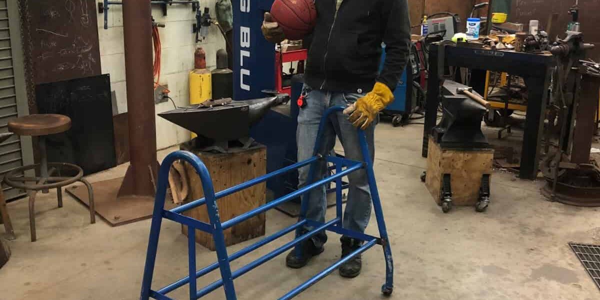 Artist working on steel frame sculpture in workshop for Pensacola Museum of Art exhibit.