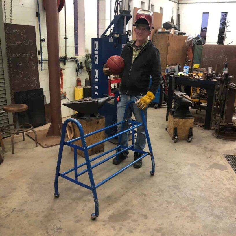 Artist working on steel frame sculpture in workshop for Pensacola Museum of Art exhibit.