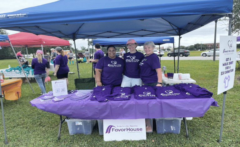 ECorsair booth at community event supporting domestic violence victims.