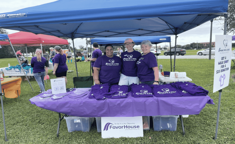 ECorsair booth at community event supporting domestic violence victims.