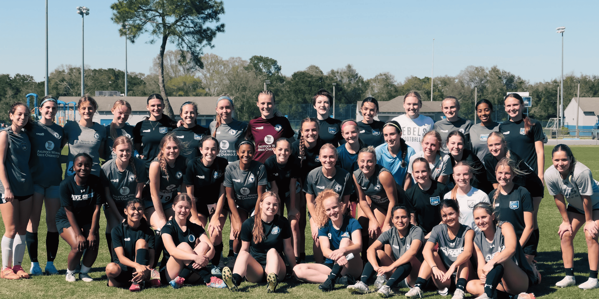 Female soccer team at Pensacola FC practicing on the field.
