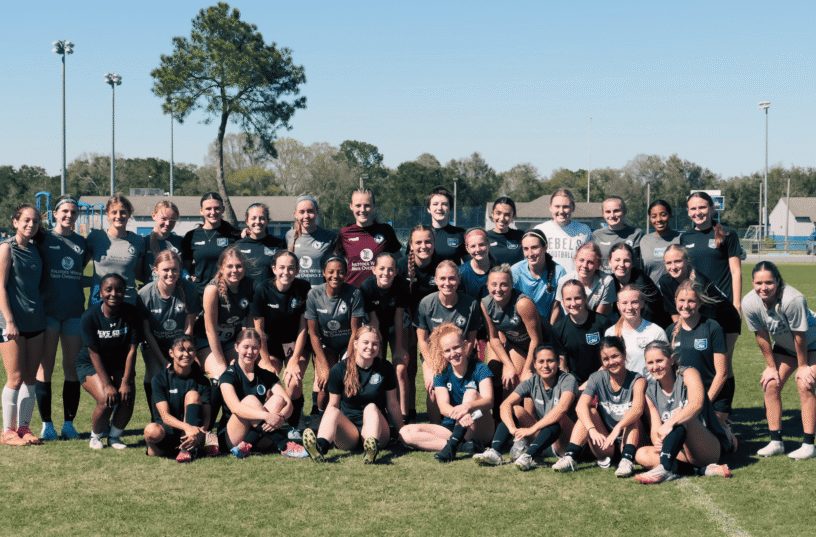 Female soccer team at Pensacola FC practicing on the field.