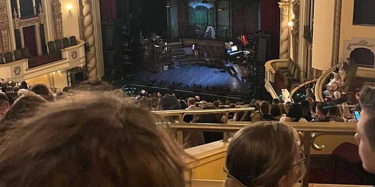 Audience watching Hadestown performance at historic Saenger Theatre in Pensacola.