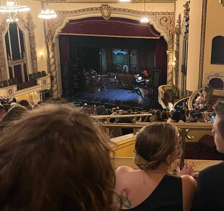 Audience watching Hadestown performance at historic Saenger Theatre in Pensacola.