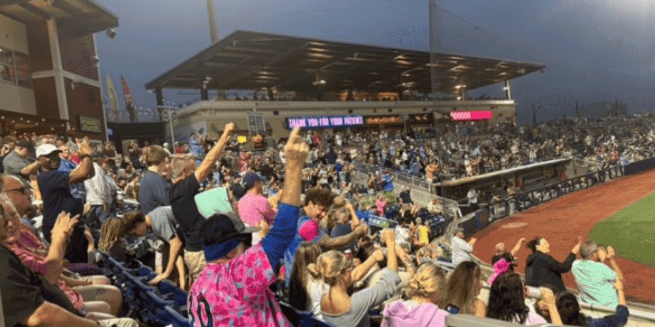 Fan crowd enjoying a game at Blue Wahoos Stadium during evening hours.