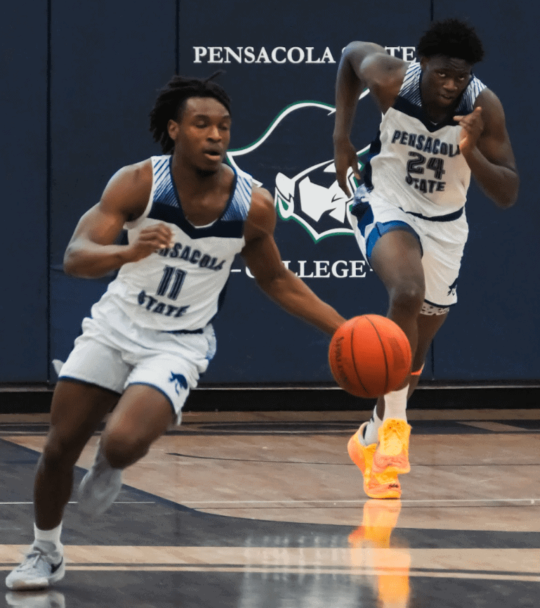 Pensacola State College basketball players in action during a game.