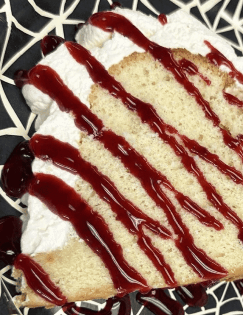 Lemon Chiffon Cake with Blackberry Glaze Lemon chiffon cake with whipped cream and blackberry glaze, perfect for desserts.