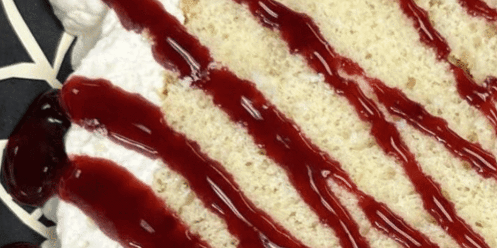 Lemon Chiffon Cake with Blackberry Glaze Lemon chiffon cake with whipped cream and blackberry glaze, perfect for desserts.