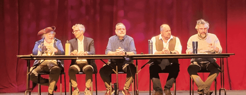 Panel of five people speaking at PSC’s Constitution Day event on a stage with red curtains.