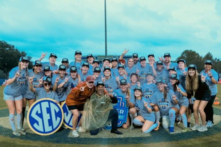 Youth soccer team celebrating victory at Pensacola sports field.