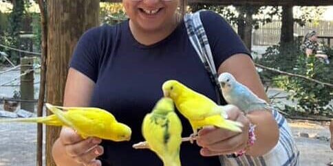 Feeding parrots at the zoo during Boo at the Zoo event.