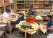 Archivists digitizing historical editions of The Corsair at Chadbourne Library.