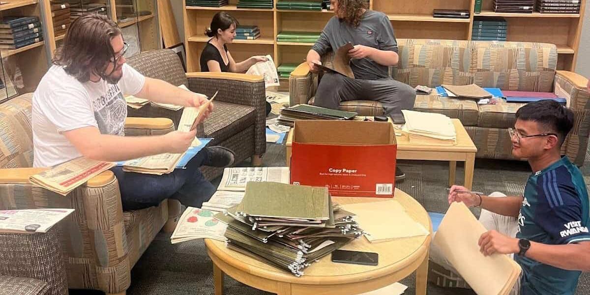 Archivists digitizing historical editions of The Corsair at Chadbourne Library.