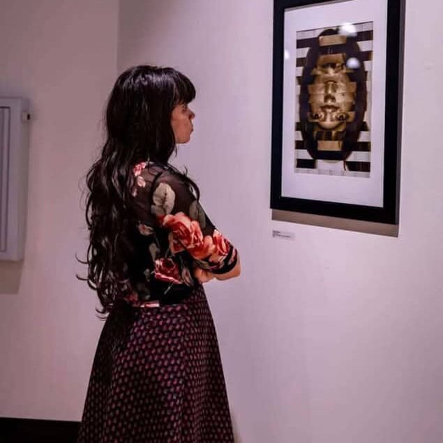 Image of student looking at art.