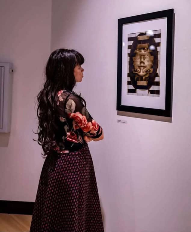 Image of student looking at art.